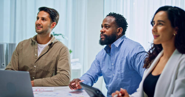 istock Group of business professionals meeting reviewing global data analytics presented on a large screen, discussing strategy and growth at the office. Finance meeting concept. 2197902408