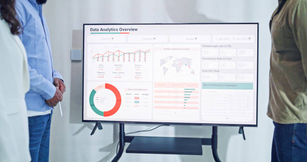 istock Closeup group of business professionals meeting discussing data analytics during a presentation, discussing strategy and growth standing at the office. Finance meeting concept. 2197902485