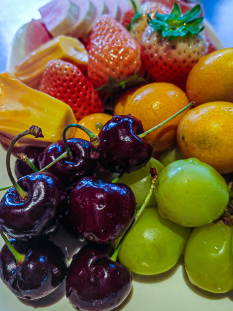 istock Fruits plate with grapefruit, kiwi and orange slices on white background 2197903012