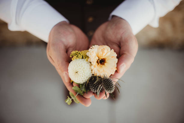 Zinnias in yellow and white in flower boutonniere for wedding