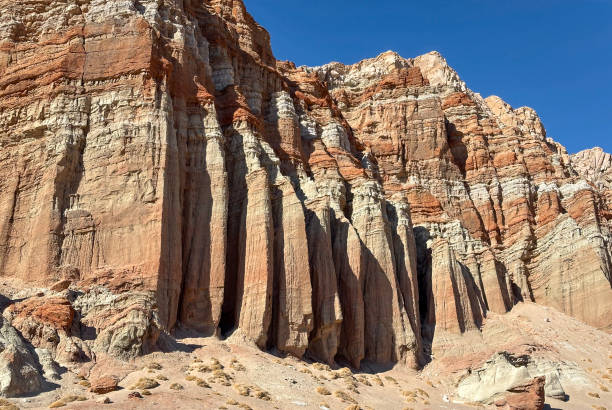 A row of rock fins eroded into the rock cliff face at Red Cliffs, Red Rock Canyon State Park, California.