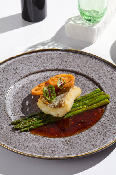 istock Modern Culinary Art Cod Fillet with Asparagus and Lotus 2197910738