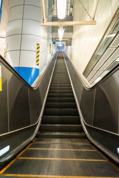 istock Vertical empty metal escalator steps at an underground metro station. Municipal transport concept copy space background 2197912945