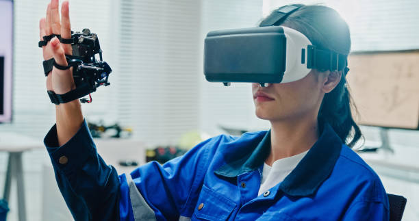 istock Closeup Young female engineer using virtual reality to design and control robotics arm in tech lab. Smart glasses analyze, and simulate AI and automated systems. AI and Robotics Development. 2197913284