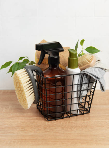 istock Eco friendly cleaning products inside metal basket on wooden table 2197913510