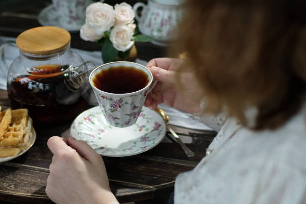 istock Woman drinking freshly brewed black tea during breakfast 2197913837