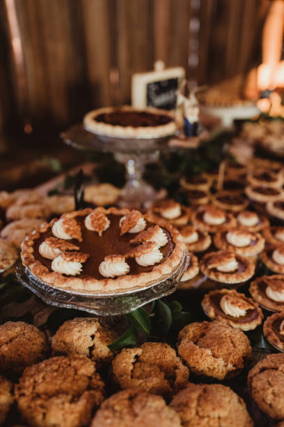 Pumpkin pie on dessert table with muffins and pecan pies