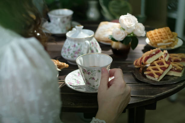istock Tea time. Woman drinking tea from porcelain tea cup 2197913986