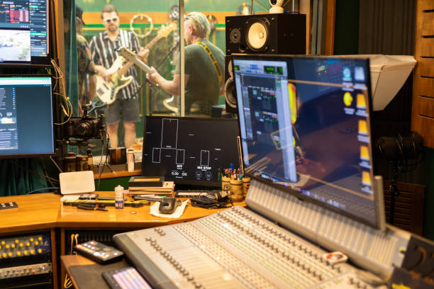 istock Middle aged rock musicians in a recording studio 2197914579