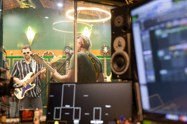 istock Middle aged rock musicians in a recording studio 2197914594
