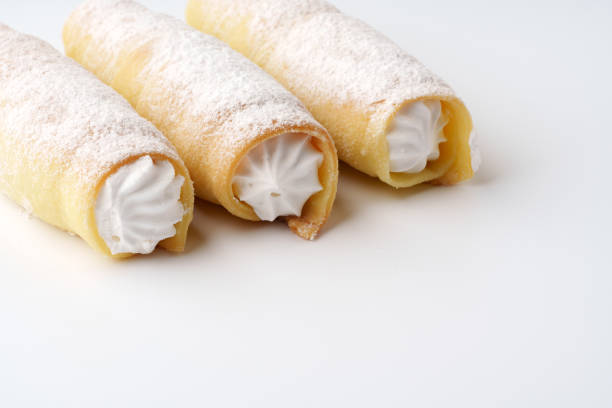 istock Delicious cream-filled pastries sprinkled with powdered sugar on a clean surface 2197914675