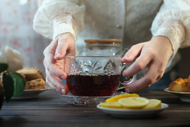 istock Morning tea party. Woman drinks her tea in comfortable kitchen setting. 2197914795