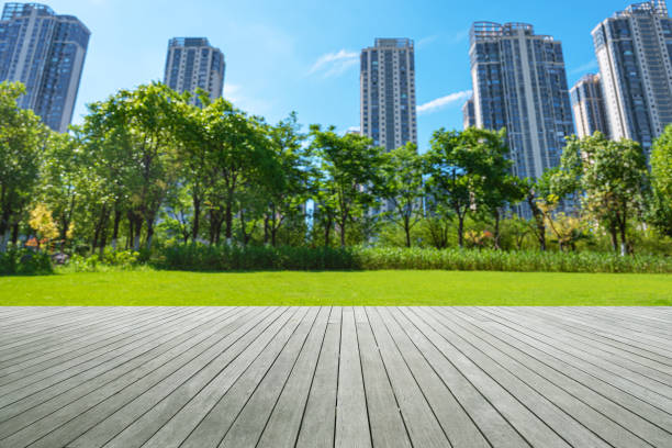 istock Empty wooden platform with green city park blurred abstract background 2197915025