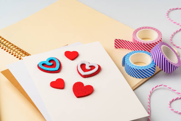 istock Crafting colorful heart decorations with felt and tape on a blank notebook during a creative session 2197915232