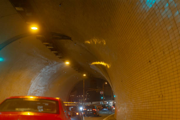 istock A vibrant red car is smoothly driving through a tunnel during the night 2197916644