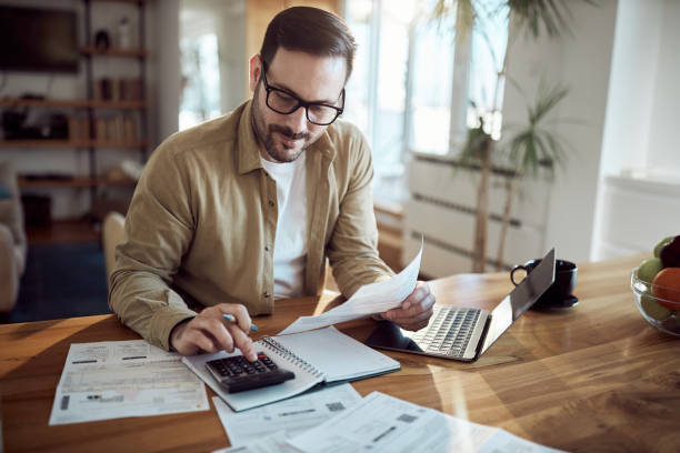 istock Young man working on his financial bills at home. 2197917406