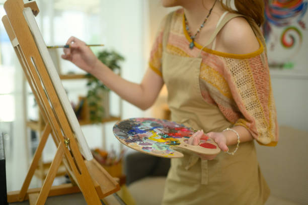 istock Cropped shot of artist holding palette while creating artwork on a canvas 2197917496