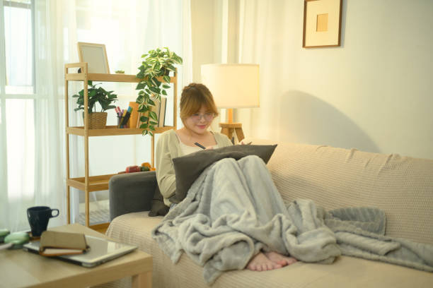 istock Young asian woman relaxing and writing in a planner 2197917525