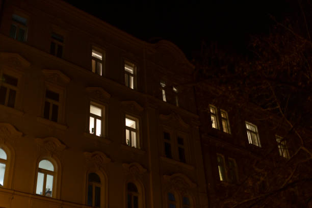 istock Nighttime Urban Building with Illuminated Windows and Dark Background 2197917703