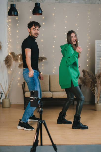A dynamic dance duo is beautifully captured in a trendy, energetic studio setting