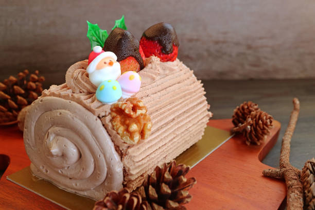 Buche de Noel on Wooden Breadboard Surrounded with Natural Dried Pinecones