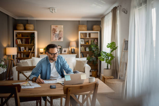 istock Happy man working from home, enjoying his productivity 2197920273