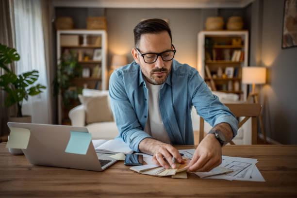 istock Focused interior designer at home, planning with a color palette 2197920365