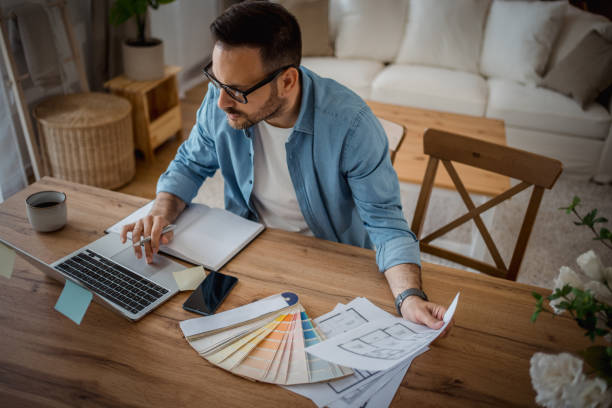 istock Focused interior designer at home, planning with a color palette 2197920378