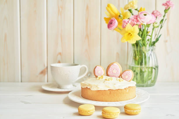 Easter composition with sweet bread, Easter cake, eggs, bouquet of flowers. Holidays breakfast concept with copy space. Traditional easter cake with gingerbread cookies. Easter Greeting Card Template.