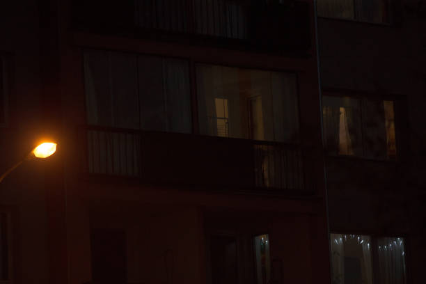 istock Night View of Illuminated Apartment Windows and Street Light 2197921626