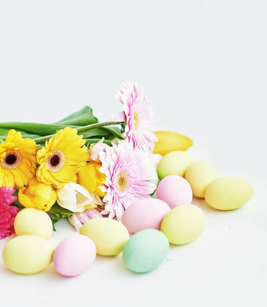 Easter composition with sweet bread, Easter cake, eggs, bouquet of flowers. Holidays breakfast concept with copy space. Traditional easter cake with gingerbread cookies. Easter Greeting Card Template.