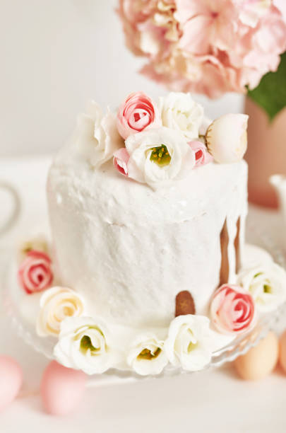 Easter composition with sweet bread, Easter cake, eggs, bouquet of flowers. Holidays breakfast concept with copy space. Traditional easter cake with gingerbread cookies. Easter Greeting Card Template.