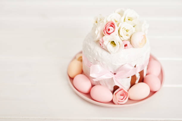 Close-up of basket filled with Easter gingerbread cookies shaped of Easter egg, bunny and flowers decorated with icing. Soft focus.