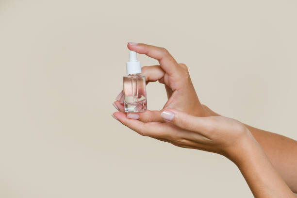 istock Woman holding essential oil bottle with dropper 2197925697