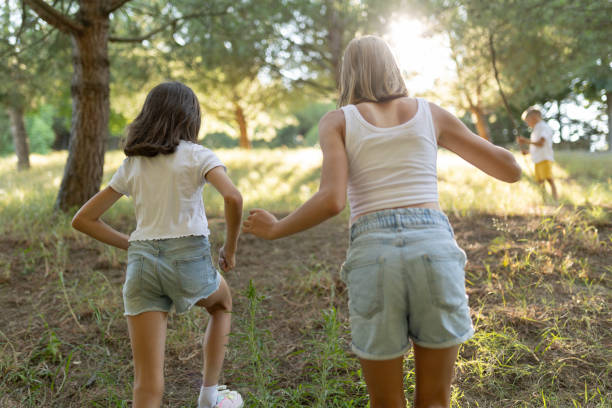 istock Children exploring nature in a sunlit forest 2197925968