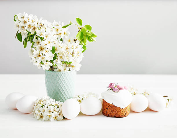 istock Easter sweet bread, Easter cake with flowers and gingerbread. Holidays breakfast concept with copy space. Easter greeting card template. Homemade pasques.Easter sweets on white background. 2197926453