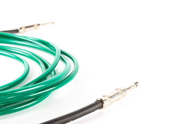 Green guitar cable isolated on white background with copy space, music production. High quality photo