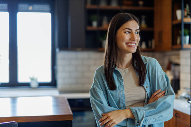 istock Young Adult Woman Smiling in Modern Kitchen 2197927770