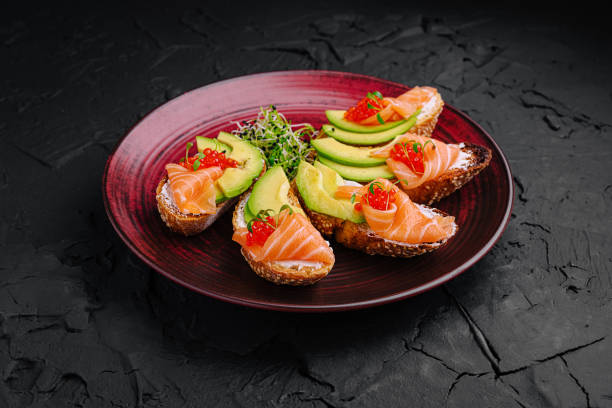istock Delicious appetizers with salmon, avocado, and caviar served on a decorative plate for a gourmet experience 2197928104