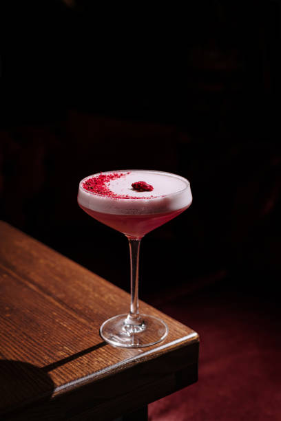 istock Sipping a vibrant raspberry cocktail in an ambient bar setting at night 2197928182