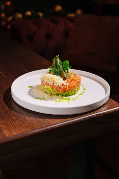 istock Exquisite culinary creation featuring layered ingredients on a stylish plate in an ambient dining environment 2197929239