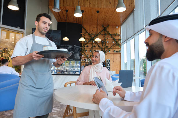 istock Waiter serving coffee to customers 2197931044