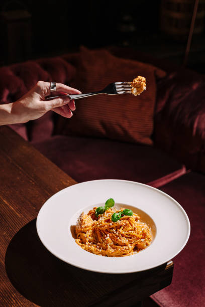 istock Beautifully plated pasta dish being enjoyed in a cozy dining setting with warm lighting 2197931429