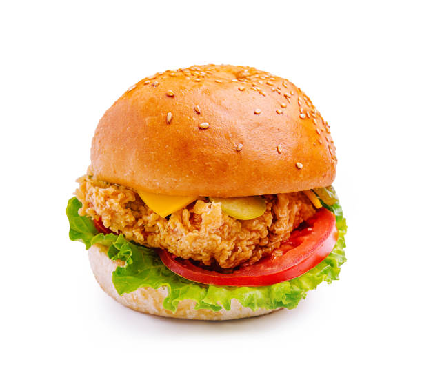 istock Crispy fried chicken sandwich with lettuce, tomato, and cheese on a sesame seed bun served on a white background 2197931716