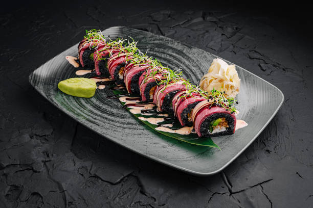 istock Delicious sushi roll presented elegantly on a dark plate with wasabi and pickled ginger 2197931958