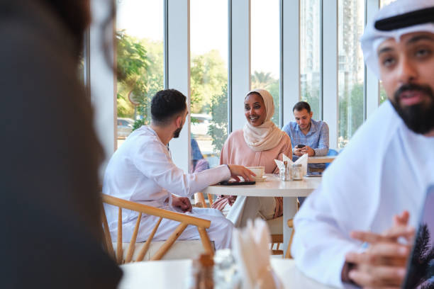 istock Smiling woman talking with man in cafe 2197932231