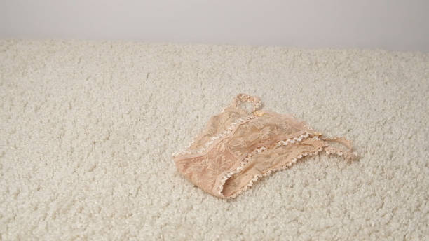istock Women's lace panties lie on a white, soft carpet. 2197933402