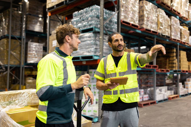 istock Warehouse Workers Collaborating and Organizing Inventory Shelves 2197933950