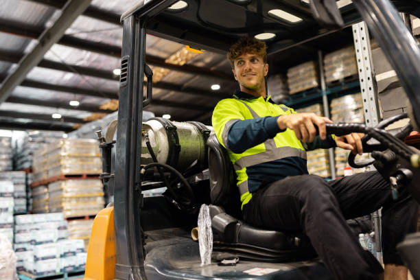 istock Warehouse Worker Operating Forklift Amidst Pallet Racks in a Logistic Center 2197934302