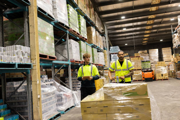 istock Warehouse Workers Organizing Pallets and Inventory in Industrial Storage Facility 2197936362